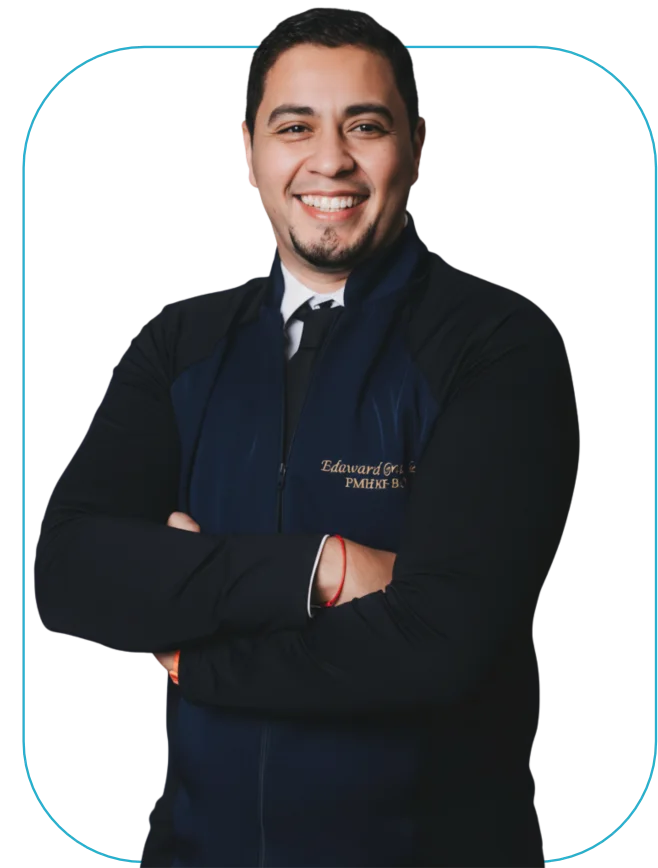 Eduward Grandes smiling, wearing his clinical jacket